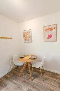 a dining room with a table and two chairs at Studio - Washington 4 in Le Havre +25 photos