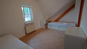 a small room with a bed and a window at alte Bäckerei Ottendorf-Okrilla #Robert# im Norden von Dresden, WLan, Netfix in Ottendorf-Okrilla