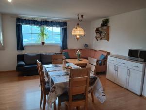 a dining room and living room with a table and chairs at Dirnbergerhof in Mondsee