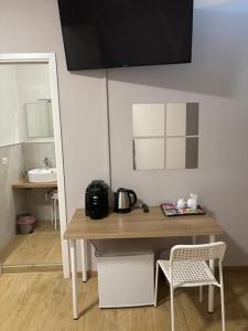 a small kitchen with a table and a sink at Le tre Vele in La Spezia +16 photos