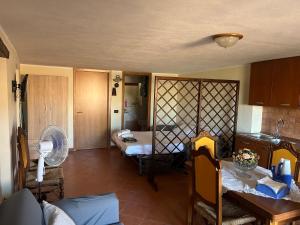 a kitchen with a room with a bed and a table at Ophi House in Badolato