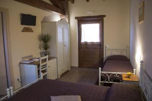 En eller flere senge i et værelse på Agriturismo L'Antico Sapore
