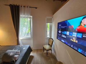 a bedroom with a large flat screen tv on the wall at Villa Joy Verona - Lovely Suite in Verona