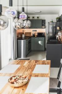 a kitchen with a pizza on a wooden table at Borovilla in Kismaros +12 photos