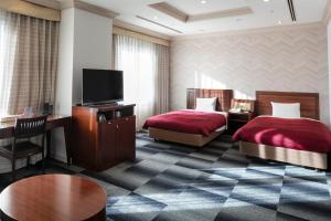 Postel nebo postele na pokoji v ubytování Narita Gateway Hotel