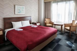 Postel nebo postele na pokoji v ubytování Narita Gateway Hotel