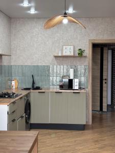 a kitchen with a washer and dryer on a counter at VIP кв 10 мкр in Oral