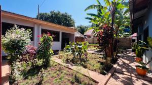 a garden in front of a house with flowers at Ava garden backpackers in Mto wa Mbu