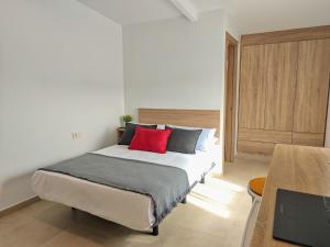 Un dormitorio con una cama con dos almohadas rojas. en Hostal Casa Miguel Marbella, en Marbella 61 fotos más