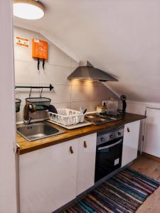 a kitchen with a sink and a stove at Lisbon Soul Surf Camp in Cascais