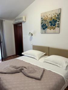 Postel nebo postele na pokoji v ubytování Hotel Vila Tina