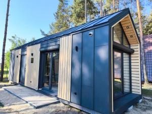 a tiny house with a blue exterior at Sportowa Osada in Strumiany