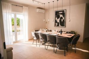 a dining room with a long table and chairs at Villa Adela in Žitnić