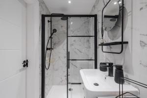 a white bathroom with a shower and a sink at Rare Historic Church Stained Glass Parking in Waterloo +22 photos