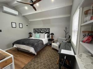 a bedroom with a bed and a ceiling fan at Almond Cottage in Riebeek-Kasteel +35 photos