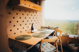 a dining room table with a bottle of wine on it at Posed Rikitan in Spálené Poříčí