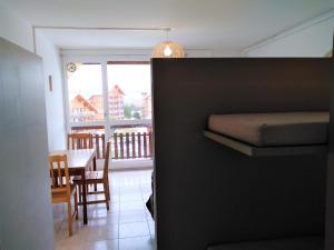 a bedroom with a bed and a dining room with a table at Le Cocon Alpin in Le Dévoluy