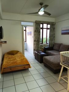 a living room with a bed and a couch at South Coast Riviera 203 in Port Shepstone