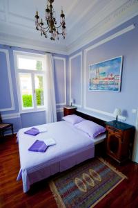 a bedroom with two beds and a chandelier at Apartman Isadora in Opatija