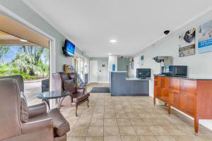 a waiting room at a hospital with chairs and a table at Studio 6 Extended Stay - Summerville, SC - Charleston in Summerville