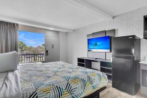 サマービルにあるStudio 6 Summerville, SC Charlestonのベッドと薄型テレビのある寝室