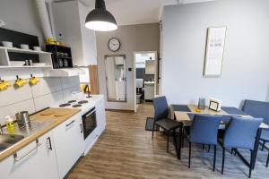 a kitchen and dining room with a table and chairs at Apartman833 in Subotica +12 photos