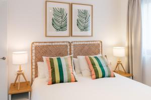 a bedroom with a bed with two pictures on the wall at Apartamentos Vista Montaña in Cangas de Onís