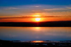 a sunset over a large body of water at BRISA del MAR in Isla Cristina