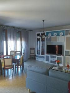 a living room with a couch and a table at Villa Ornella in Luni