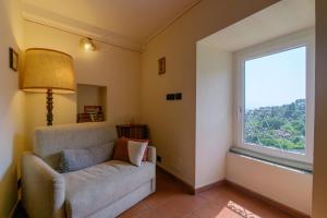 a living room with a couch and a window at Taverna delle Mura in Ameglia