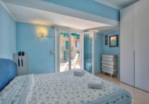 a bedroom with a bed and a sliding glass door at Colombo Flexyrent Studio in Rapallo