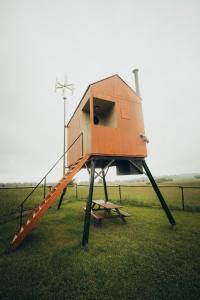 a play house with a staircase in the grass at Posed Rikitan in Spálené Poříčí +15 photos