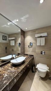 a bathroom with two sinks and two toilets at Grand Ocean Sokhna Hotel & Resort in Ain Sokhna
