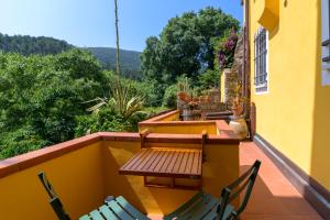 a balcony with a table and chairs on a building at Taverna delle Mura in Ameglia