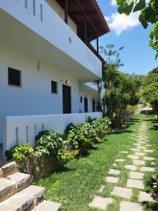 a walkway in front of a white building at IRIDA Studios Hotel & Pool in Plakias