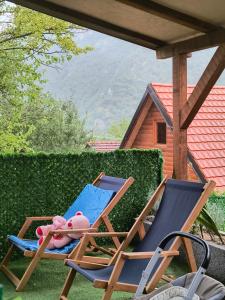 a pair of chairs with a stuffed animal sitting on them at Vikendica sa bazenom"Mila"Banja Topilo in Banja Topilo