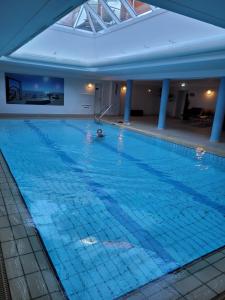 a person swimming in a large swimming pool at Fewo Büsum in Büsum