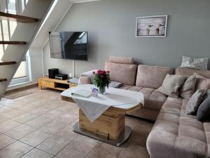 a living room with a couch and a table at Fewo Büsum in Büsum