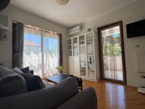 a living room with a couch and a large window at Emerald hills apartment in Baošići