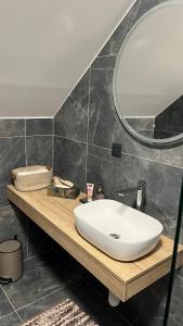 a bathroom with a white sink and a mirror at Móló Pension in Trstice