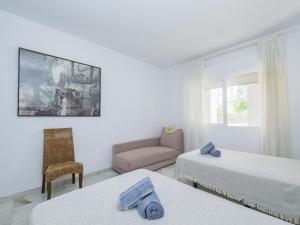 1 Schlafzimmer mit 2 Betten, einem Stuhl und einem Sofa in der Unterkunft Cubo's Villa La Butibamba in La Cala de Mijas + 79 Fotos