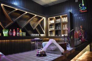 a bar with a table and a shelf of alcohol at Hotel Manish Mansion in Lumbini