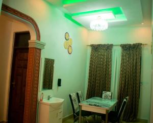 a room with a table and a sink and a table and a mirror at Amani home in Nkunjila