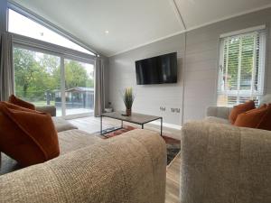 a living room with two couches and a tv at V29 - Rivers Retreat in Bethesda