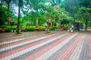 a park with trees and a red and white sidewalk at Amani home in Nkunjila