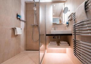 a bathroom with a shower and a sink at Thalazur Ouistreham - Hôtel & Spa in Ouistreham