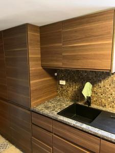 a kitchen with wooden cabinets and a sink at Villa chaimae in Lii