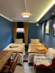 a room with two beds and a table in it at Villa chaimae in Lii
