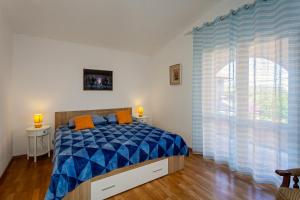 a bedroom with a bed and a large window at Spacious Terrace Apartments in Rogoznica