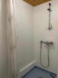 a shower in a bathroom with a shower curtain at Atmoshperic countryside house in Vehmaa